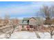 Charming two-story home featuring a covered porch, well-maintained lawn, and mature trees at 225 Longspur Dr, Brighton, CO 80601