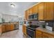 Functional kitchen with ample cabinetry and stainless steel appliances at 225 Longspur Dr, Brighton, CO 80601