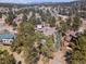 Aerial view of a secluded home nestled among lush trees and natural beauty at 31607 Broadmoor Dr, Evergreen, CO 80439
