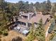 Stunning aerial view of the property showcasing the lush landscaping and expansive outdoor living spaces at 31607 Broadmoor Dr, Evergreen, CO 80439