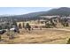 Aerial view of neighborhood with houses and mountains in the background at 31607 Broadmoor Dr, Evergreen, CO 80439