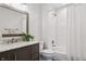 Charming bathroom with marble countertops, dark wood vanity, and white subway tiled shower/tub at 31607 Broadmoor Dr, Evergreen, CO 80439