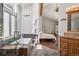 Beautiful bathroom featuring tub, slate floors, wood vanity and natural light adjoins open bedroom at 31607 Broadmoor Dr, Evergreen, CO 80439