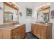 Bathroom features dual vanities with granite counters, warm wood cabinets, and slate tile flooring at 31607 Broadmoor Dr, Evergreen, CO 80439