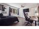This contemporary bedroom is complete with a cozy black bed, wooden floors and dark furniture at 31607 Broadmoor Dr, Evergreen, CO 80439