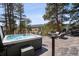 Relaxing hot tub on an outdoor deck with beautiful views of the surrounding natural landscape at 31607 Broadmoor Dr, Evergreen, CO 80439