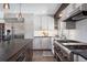 Modern kitchen featuring stainless steel appliances, custom cabinetry, and stone countertops at 31607 Broadmoor Dr, Evergreen, CO 80439