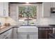 Charming kitchen featuring a farmhouse sink and a picturesque view of the outdoors at 31607 Broadmoor Dr, Evergreen, CO 80439