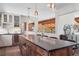 Modern kitchen with a large island, stainless steel appliances, and a seamless flow into the adjacent dining and living spaces at 31607 Broadmoor Dr, Evergreen, CO 80439