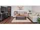 Cozy living room showcasing a plush sofa, stylish decor, and hardwood floors at 31607 Broadmoor Dr, Evergreen, CO 80439