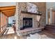 Living room featuring a stone fireplace, hardwood floors, and elegant decor at 31607 Broadmoor Dr, Evergreen, CO 80439