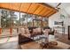 Relaxing sunroom featuring wood ceilings, hardwood floors, and comfortable seating with great views of nature at 31607 Broadmoor Dr, Evergreen, CO 80439