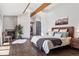 Bright and airy main bedroom with wood floors, fireplace, walk-in closet, and modern ensuite bathroom at 31607 Broadmoor Dr, Evergreen, CO 80439