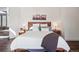 Bright main bedroom boasts hardwood floors, king bed, and neutral colors to create a soothing retreat at 31607 Broadmoor Dr, Evergreen, CO 80439