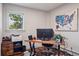 Well-lit office space with wood desk, comfortable chair, and a view of the outdoors at 31607 Broadmoor Dr, Evergreen, CO 80439