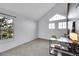 Sunlit bedroom boasts a large window, modern desk, and gray carpet for a comfortable retreat at 11109 Alcott St # D, Westminster, CO 80234