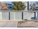 Photo of garages with painted wooden siding, concrete driveway, and an evergreen tree in background at 11109 Alcott St # D, Westminster, CO 80234