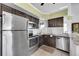 Stainless steel appliances and dark wood cabinets in kitchen at 11109 Alcott St # D, Westminster, CO 80234