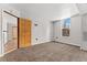 Bedroom with neutral carpet and a window offering natural light and an open doorway at 601 W 11Th Ave # 109, Denver, CO 80204