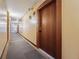 Building hallway with wood doors and carpet at 601 W 11Th Ave # 109, Denver, CO 80204