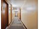 Building hallway with wood doors and carpet at 601 W 11Th Ave # 109, Denver, CO 80204