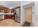 Open concept kitchen with stainless steel appliances and wood cabinets at 601 W 11Th Ave # 109, Denver, CO 80204