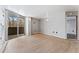 Bright, empty living room with wood floors and access to a balcony and other rooms at 601 W 11Th Ave # 109, Denver, CO 80204