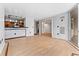 Open concept living area with wood flooring, bar area and sliding glass doors to balcony at 601 W 11Th Ave # 109, Denver, CO 80204