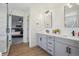Modern bathroom boasts double vanities, sleek fixtures, and a glass-enclosed shower with wood-style floor at 4763 Laurelglen Ln, Highlands Ranch, CO 80130