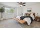 Bright bedroom features a large window, neutral color palette, stylish furniture, and plush carpeting at 4763 Laurelglen Ln, Highlands Ranch, CO 80130
