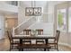 Dining room showcasing wood table with modern chandelier and staircase to the side at 4763 Laurelglen Ln, Highlands Ranch, CO 80130