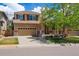 Charming two-story home featuring a covered front porch, two-car garage, and well-maintained front yard at 4763 Laurelglen Ln, Highlands Ranch, CO 80130