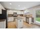 Bright kitchen featuring white cabinetry, granite countertops, stainless steel appliances, and a center island at 4763 Laurelglen Ln, Highlands Ranch, CO 80130