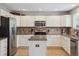Well-lit kitchen boasts white cabinets, stainless steel appliances, granite countertops, and tile backsplash at 4763 Laurelglen Ln, Highlands Ranch, CO 80130