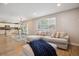 Cozy living room with access to the kitchen, large windows, and a comfortable sectional sofa with ottoman at 4763 Laurelglen Ln, Highlands Ranch, CO 80130