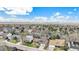 Scenic aerial view of a residential area with tree-lined streets and mountain views in the distance at 5115 E Davies Dr, Centennial, CO 80122
