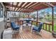 Relaxing back deck featuring an overhead pergola, blue outdoor seating, and a fenced yard at 5115 E Davies Dr, Centennial, CO 80122
