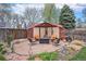 Inviting backyard patio with pergola, seating and a privacy fence at 5115 E Davies Dr, Centennial, CO 80122