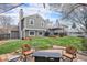 Spacious backyard featuring a patio, green lawn, and comfortable seating area at 5115 E Davies Dr, Centennial, CO 80122