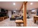 Inviting basement living area with a cozy sectional couch and a wood beam accent at 5115 E Davies Dr, Centennial, CO 80122