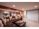 Finished basement with a comfortable sectional sofa and built-in bar area at 5115 E Davies Dr, Centennial, CO 80122