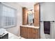 Updated bathroom featuring a vanity with storage and a granite countertop at 5115 E Davies Dr, Centennial, CO 80122