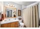 Bright bathroom featuring wood vanity and white tile shower at 5115 E Davies Dr, Centennial, CO 80122