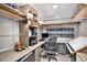 Functional home office featuring custom shelving, a large desk, and optimal storage space at 5115 E Davies Dr, Centennial, CO 80122