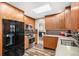Sleek kitchen featuring modern appliances, custom wood cabinets, and a bright skylight at 5115 E Davies Dr, Centennial, CO 80122