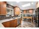 Modern kitchen featuring wood cabinetry, stainless steel appliances, and bright skylights at 5115 E Davies Dr, Centennial, CO 80122
