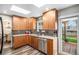 Modern kitchen with light wood cabinets, stainless steel appliances, and backyard access at 5115 E Davies Dr, Centennial, CO 80122