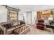 Comfortable living room with leather seating and a staircase at 5115 E Davies Dr, Centennial, CO 80122