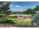 Expansive backyard featuring lush greenery and a view of the neighborhood park at 1572 W Long Ave, Littleton, CO 80120