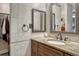 Bright bathroom features granite countertop vanity with a decorative mirror and walk-in closet at 1572 W Long Ave, Littleton, CO 80120
